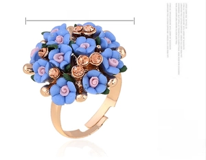 Detail view of 21mm floral cluster ring with pink and blue blossoms in rose gold setting