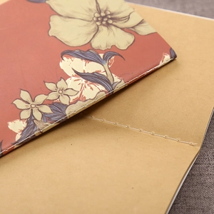 Macro detail of vintage floral notebook with durable kraft paper and stitched binding