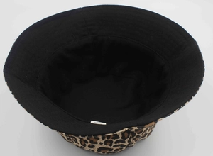 Close-up of leopard print bucket hat showing reversible black lining and inner care label