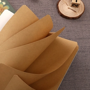Minimalist kraft paper notebook with thick brown pages shown in a fan-shaped open view