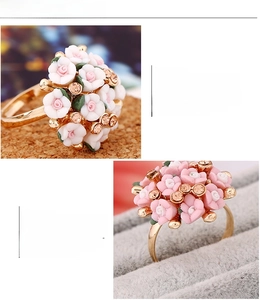 Macro detail of adjustable floral ring with pink petals and sparkling crystals in gift box