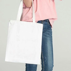 White canvas tote bag on female shoulder showing spacious design and minimalist style