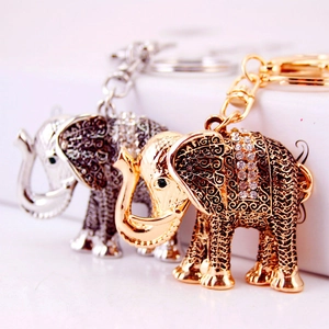 Vintage metal elephant keychain set in gold and silver with sparkling rhinestones and engravings