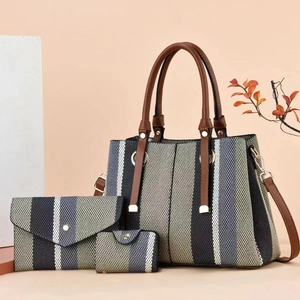 Three-piece women's handbag set with striped tote, envelope bag and small wallet in grey