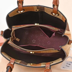 Macro view of interior compartments and floral lining of brown woven tote bag