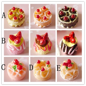 Miniature resin strawberry cake charms in nine styles with A-E index labels on pink background