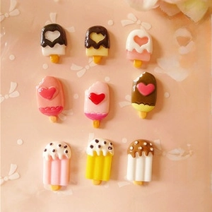 Flat lay of nine colorful resin ice cream charms for DIY phone case cream glue crafts