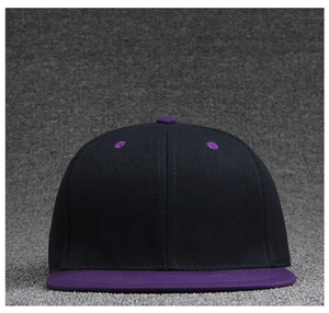 Detail view of a flat brim baseball cap with black crown and purple visor in twill cotton