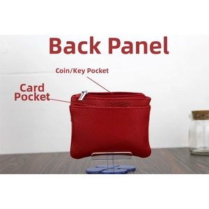Detail view of red pebble grain leather coin purse with zipper pouch and card slot