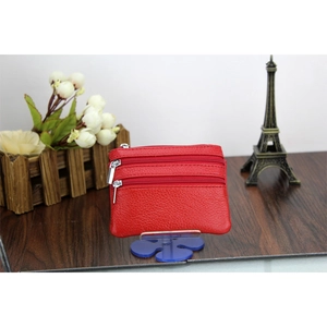 Close-up of red genuine leather coin purse with lychee texture and silver metal zippers