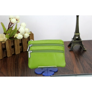 Detail view of the green leather coin purse featuring three-layer zipper compartments
