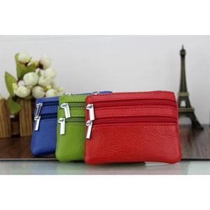 Macro shot of colorful leather coin purses with litchi texture and silver double zippers