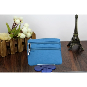 Detailed view of blue litchi grain leather coin purse with three zipper compartments