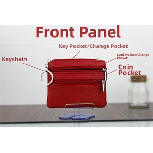 Close-up of red pebbled leather coin purse with triple zippers and silver key ring