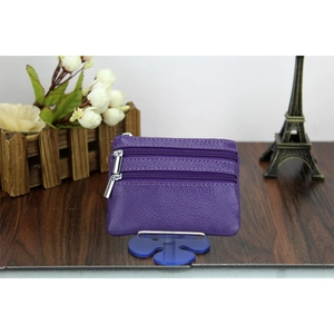 Close-up of purple genuine leather wallet with lychee texture and dual silver zippers