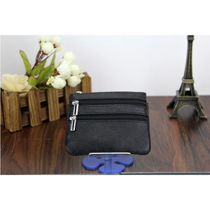Detailed macro view of black genuine pebble leather coin purse with three zipper compartments