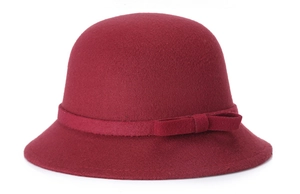 Detail shot of the wine red wool cloche hat with a matching ribbon bow decoration