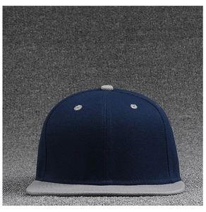 Detailed close-up of navy and grey flat brim baseball cap showing twill fabric texture