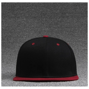 Detail shot of the red flat brim and breathable eyelets on a black snapback cap