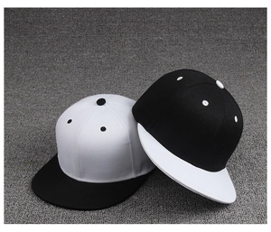 Detail of flat brim hip hop caps in contrasting black and white twill cotton fabric