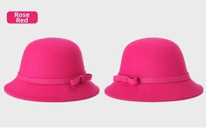 Detail of rose red wool felt cloche hat featuring a decorative ribbon and bow accent