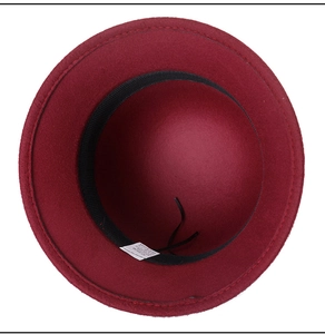 Detail view of dark red wool hat interior showing 57-58cm size label and fabric lining