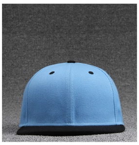 Detail of light blue and black flat brim baseball cap with twill cotton texture