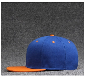 Side view of royal blue and orange contrast cotton twill flat brim baseball cap