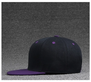 Detail view of a navy blue hip-hop cap with contrasting purple eyelets and flat brim design