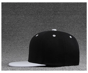Side view of two-tone flat brim baseball cap with black crown and white visor