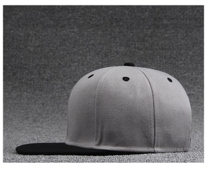 Detail of color-block baseball cap showing light grey crown and black flat brim