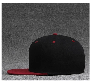 Side view of a two-tone baseball cap in black and burgundy with flat brim and vent holes