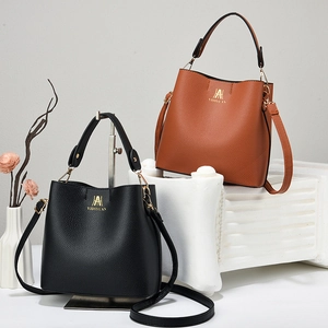Detailed view of lychee texture faux leather bucket bags in black and brown colors