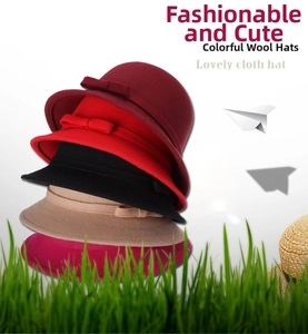 Vertical stack of multi-color wool cloche hats with bow detail in red, black, and camel