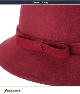 Detailed close-up of the burgundy wool cloche hat featuring a stylish bow and stitching