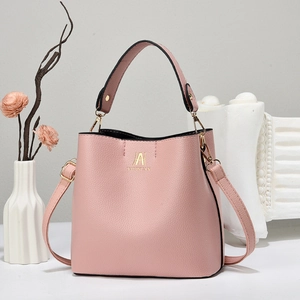 Elegant dusty pink litchi pattern bucket bag with golden handle and crossbody strap