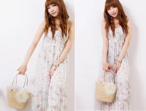 Floral tube top maxi dress in light green with a lace-decorated straw handbag