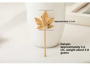 Detailed size view of a golden maple leaf hairpin measuring 5.6cm in total length