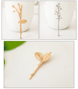 Detailed close-up showing golden and silver metal leaf hair clips with smooth polished finish