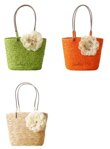 Straw woven tote bags in green, orange and beige with decorative floral details