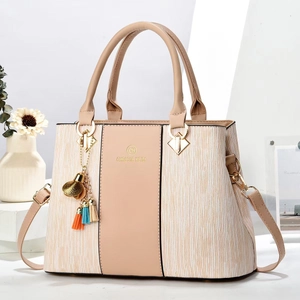 Elegant beige and apricot paneled tote bag with detachable strap and tassel accent