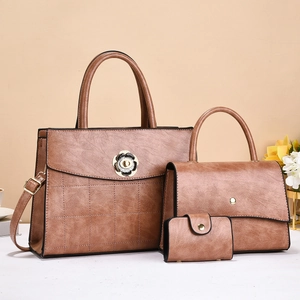 Three-piece brown faux leather handbag set with floral gold hardware and quilted texture