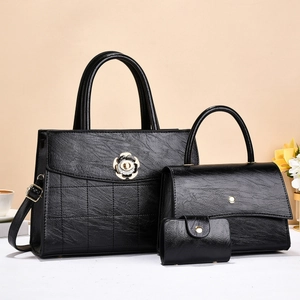 Three-piece black leather handbag set for women with elegant golden floral metal clasp