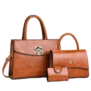 Three-piece set of caramel faux leather tote bags with quilted patterns and sun flower hardware