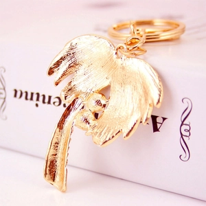 Golden rhinestone coconut tree keychain with metallic finish and tropical palm tree charm