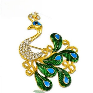 Exquisite rhinestone peacock brooch featuring gold-plated alloy and vibrant enamel details.