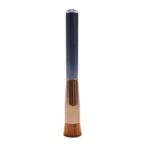 Macro view of flat top foundation brush with brown synthetic bristles and rose gold ferrule