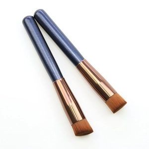 Flat foundation and concealer brushes with blue wood handles and copper ferrules