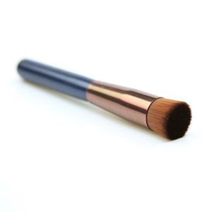 Flat head concealer brush with blue handle and brown bristles for precise makeup