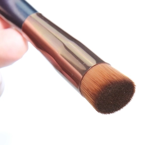 Detailed view of dense brown synthetic bristles on a flat concealer and foundation brush